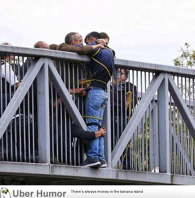 A man wanting to jump off a bridge, stopped by strangers who held him